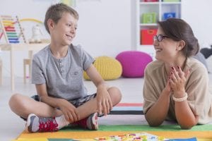Boy and therapist doing applied behaviour analysis therapy in Toronto