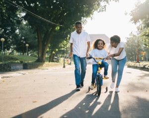 Autism ABA Therapy Lindsey Malc Side by Side Therapy parents teaching child to ride bike