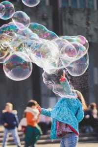 A young child plays with bubbles during a Respite in Toronto session with Side by Side Therapy
